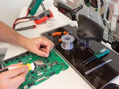 TV repair in the service center, engineer soldering electronic components